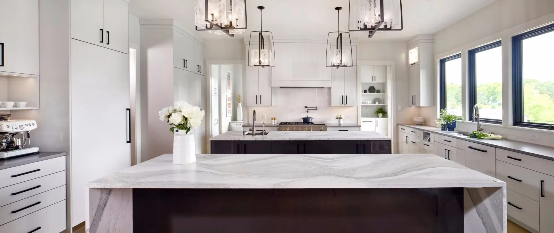 Finished luxury kitchen with stone island and custom cabinetry, the level of finish a South Florida luxury custom home builder should be able to show in completed homes