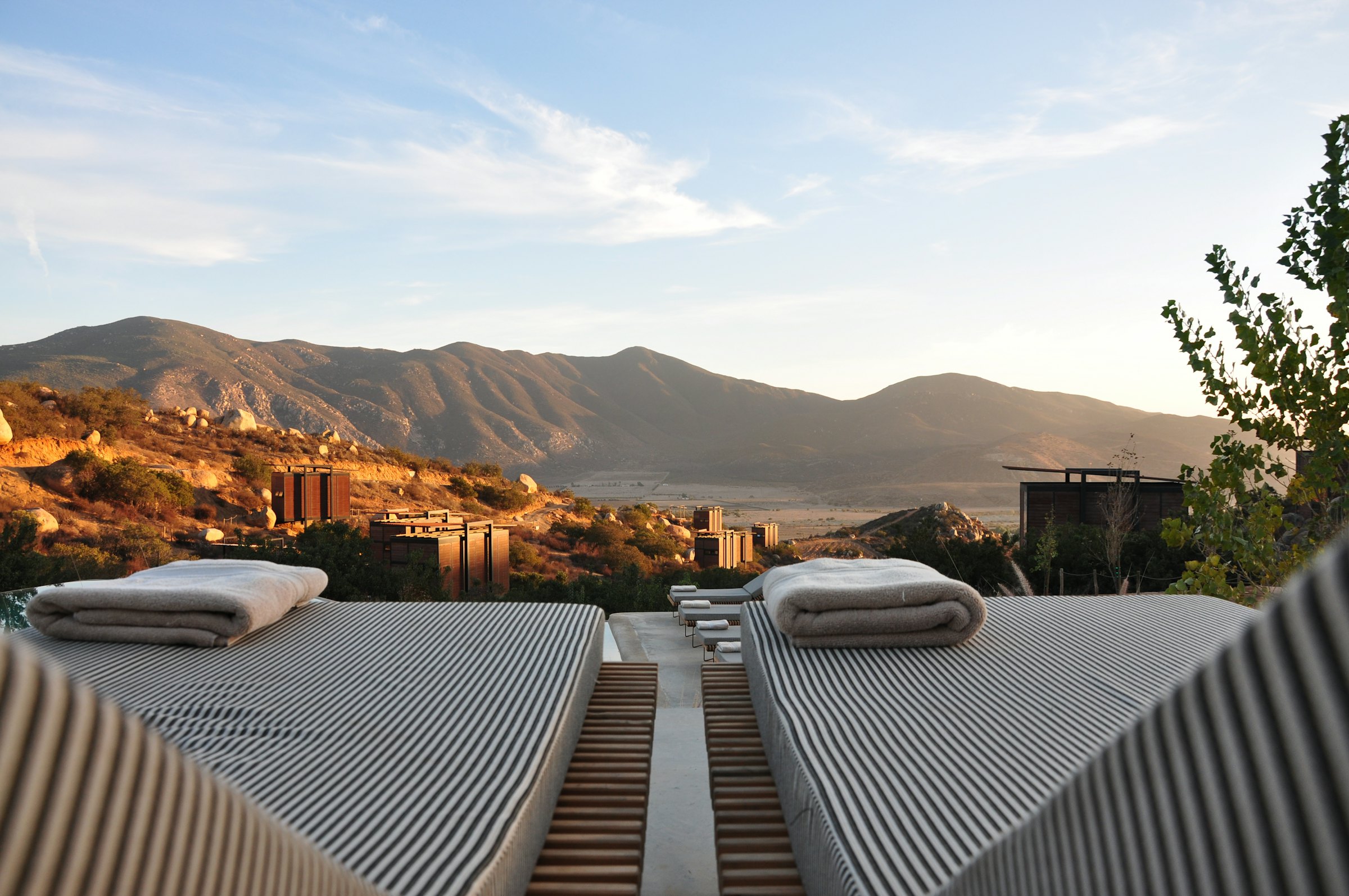 Covered outdoor terrace with lounge seating and warm lighting