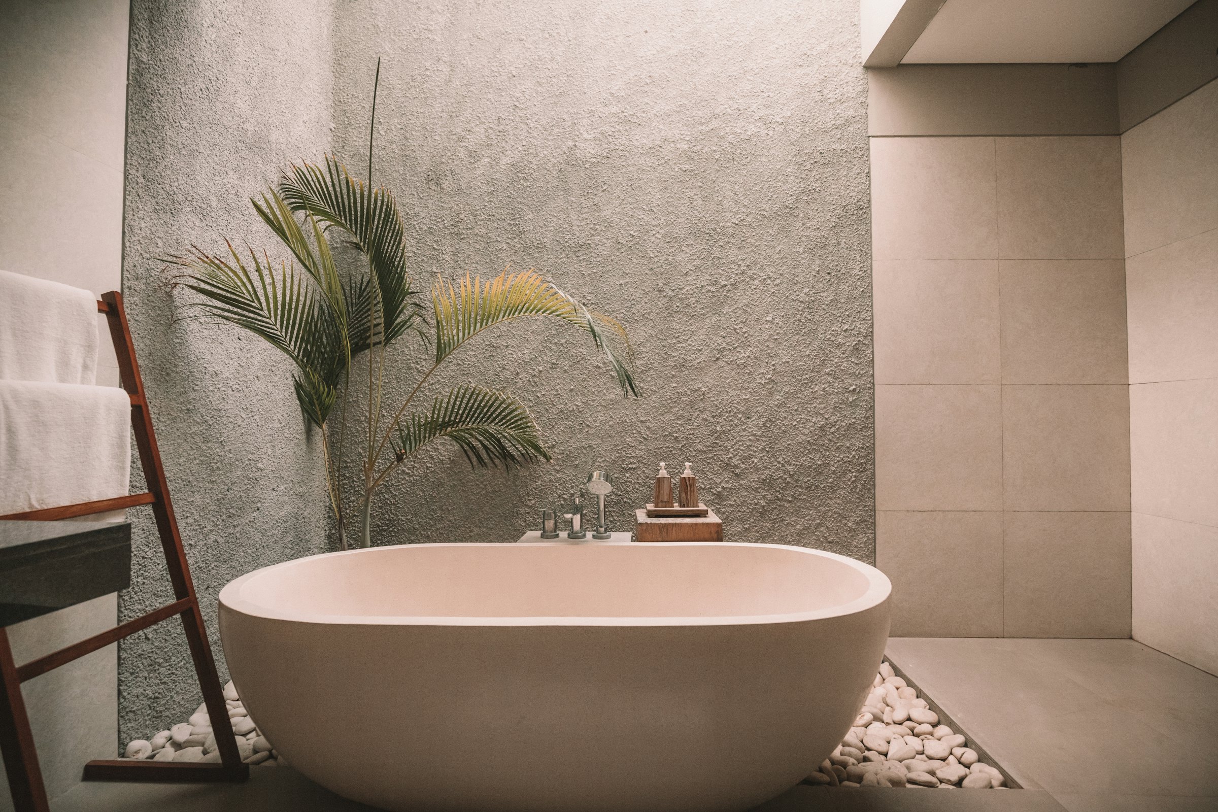 Spa-like coastal bathroom with natural stone and soft lighting