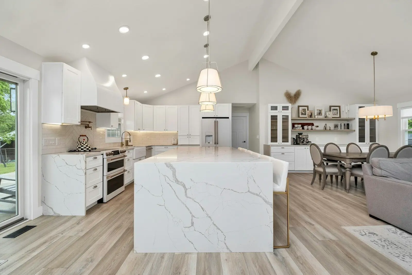 Smart Lighting and Window Treatment Systems for Coastal Luxury Homes - 1 Smart lighting and motorized shades in a coastal luxury home at dusk