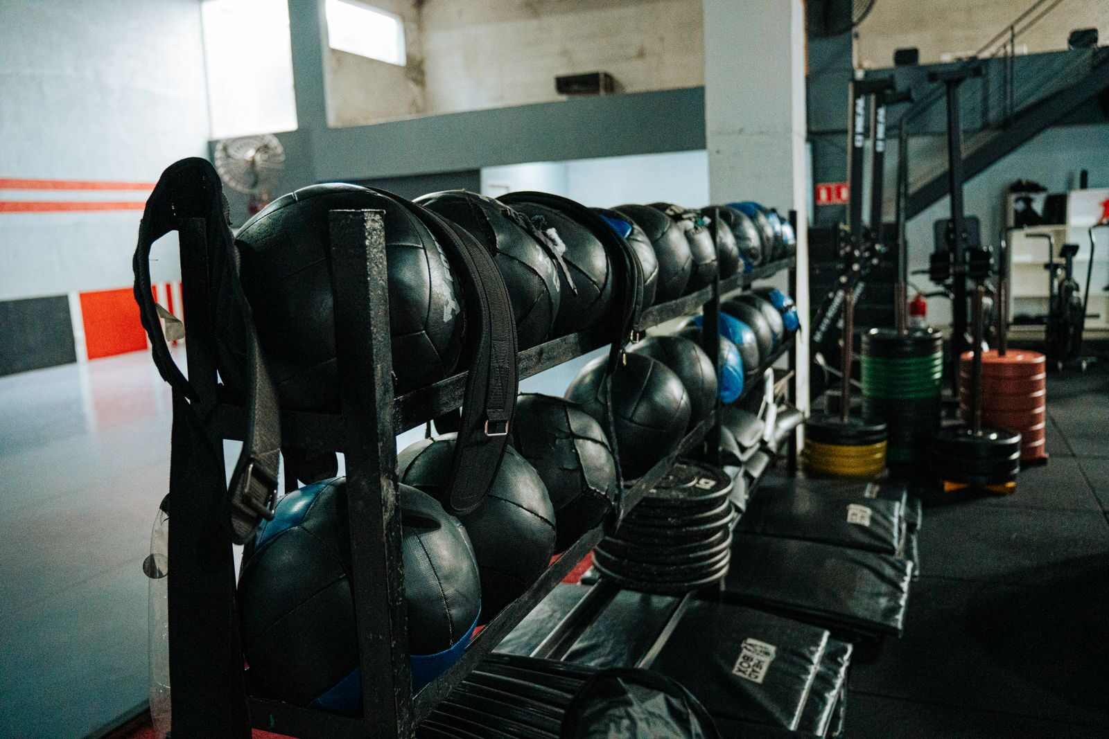 Wellness Oriented Design Features for Luxury Coastal Estates - 3 Well-equipped indoor gym featuring kettlebells, weights, and workout gear, perfect for fitness enthusiasts.