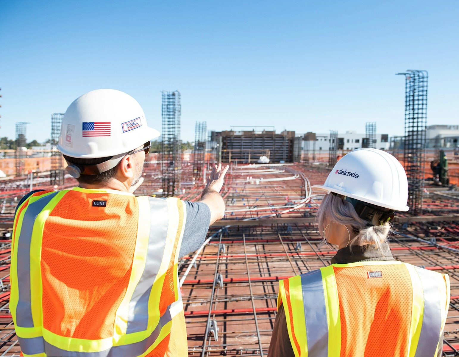 Strategic Design Decisions Long-Term Property Value in South Florida - 1 two construction workers in safety vests at site
