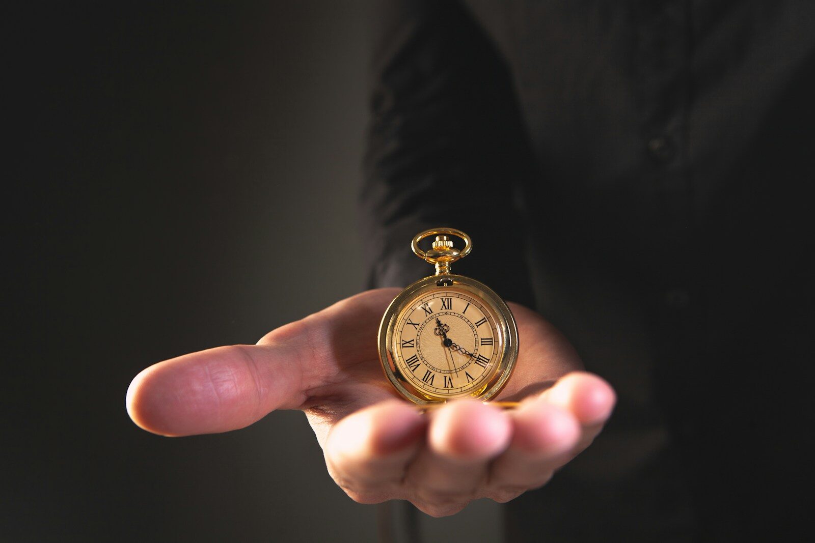 Protecting Your Build Budget from Inflation and Material Price Spikes - 3 A person holding a vintage pocket watch in their palm.