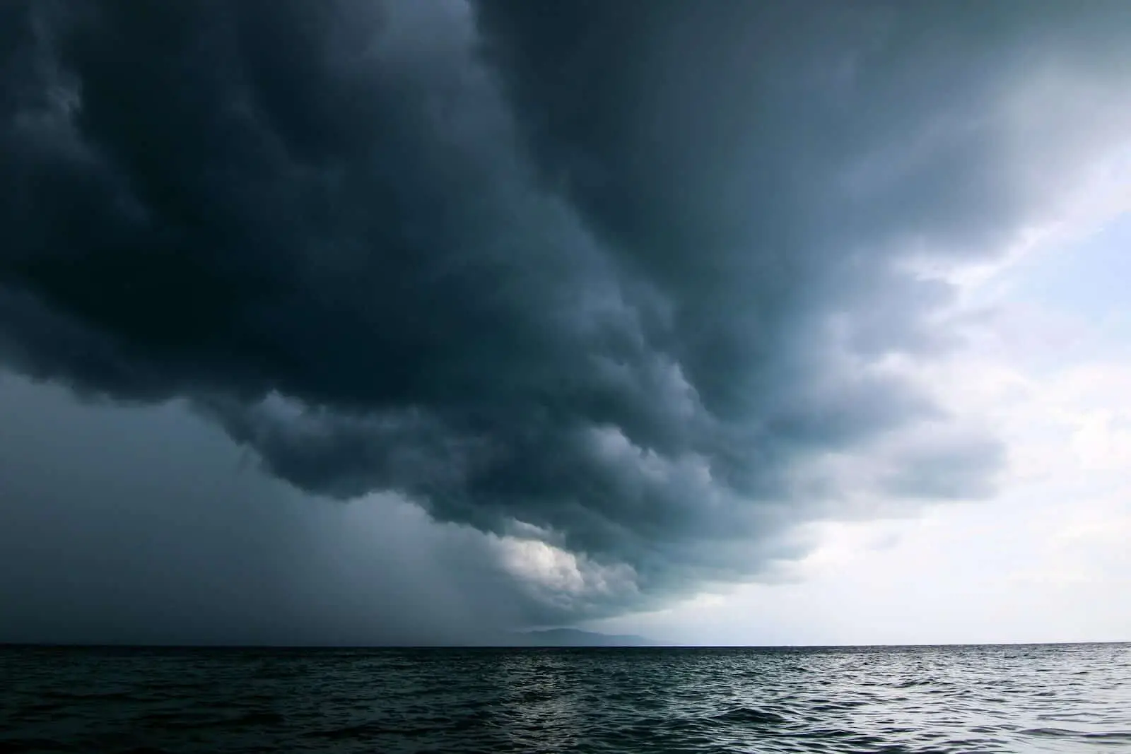 Storm moving across the sky over open water in South Florida, the climate reality behind hurricane-ready luxury home design
