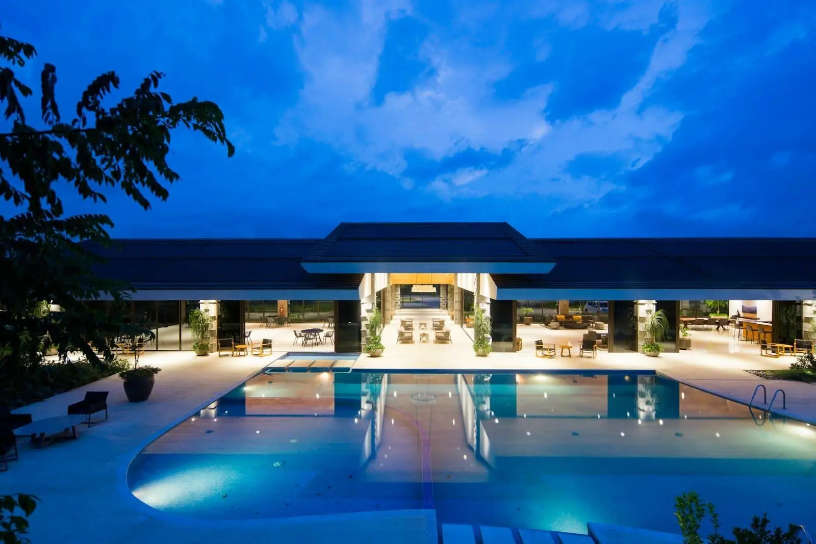 Premium Sustainable Materials for the South Florida Climate - 2 Premium sustainable materials at a waterfront South Florida home at night, with corrosion-rated finishes