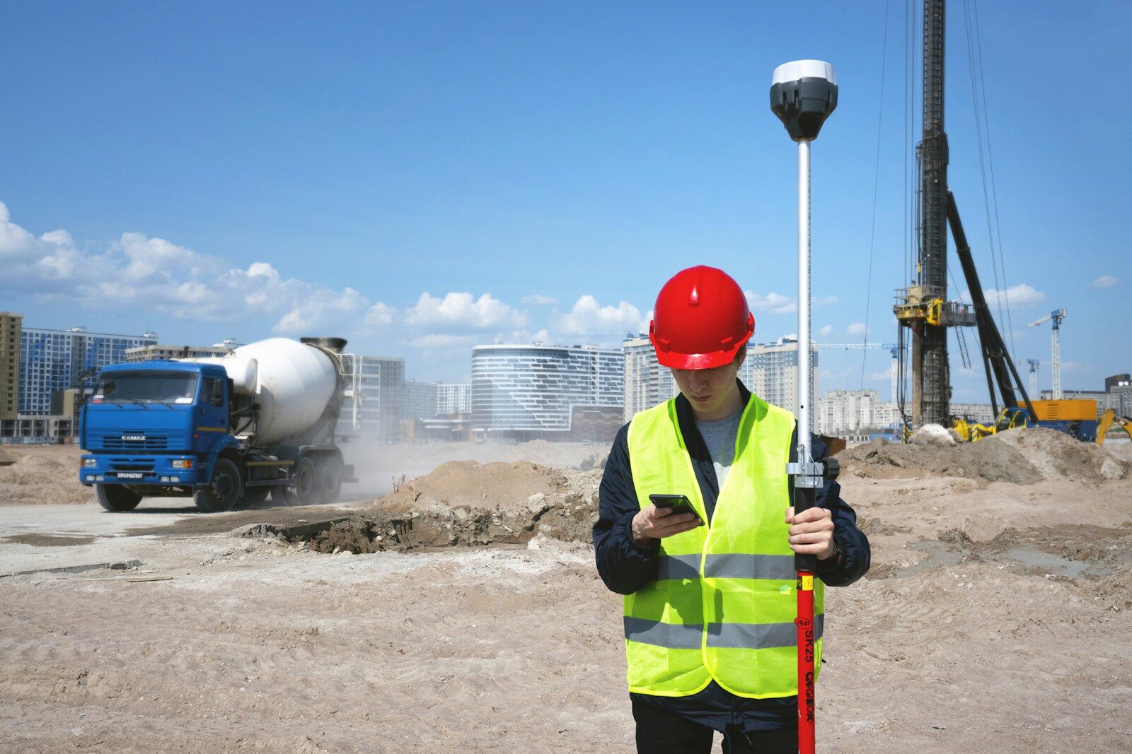 Contingency Planning for Supply Chain Issues in Luxury Construction - 1 man in black and yellow jacket wearing red helmet holding black and white stick
