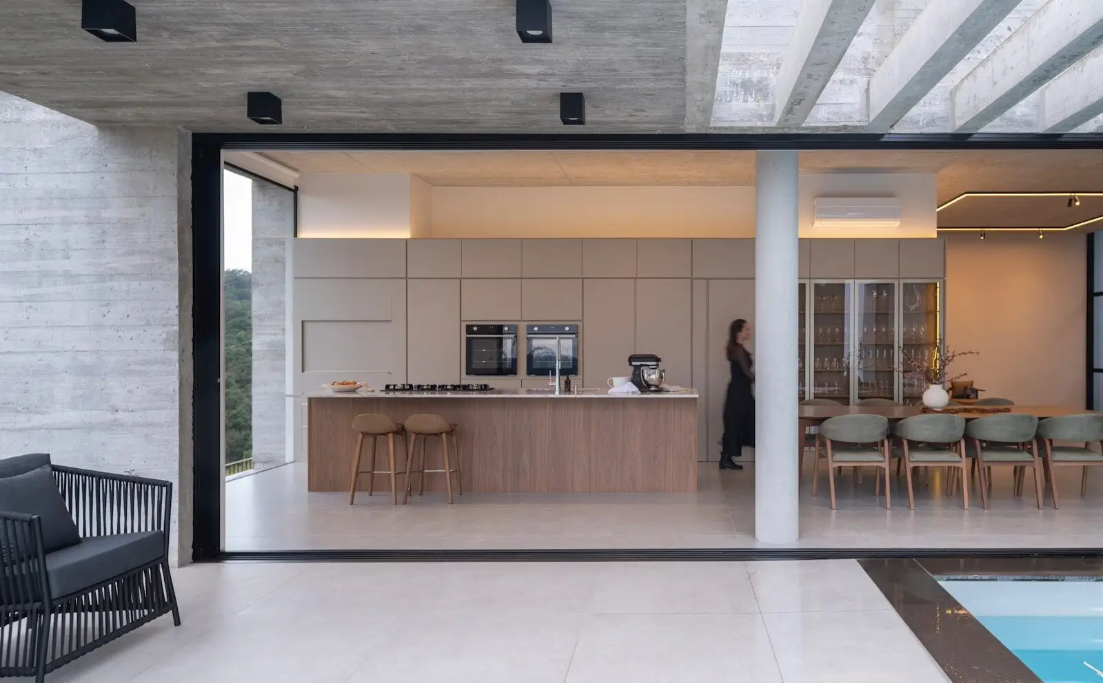 Indoor-Outdoor Living Trends & Open-Concept Reconfiguration for 2026 - 2 Modern kitchen and dining area with outdoor seating.